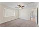 Simple bedroom with neutral walls, carpet, and ceiling fan at 14905 Pelican Point Pl, Tampa, FL 33625