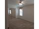 Bright bedroom featuring a ceiling fan and mirrored closet doors at 1760 Dorothy Blvd, Lutz, FL 33558