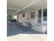 Covered carport with golf cart and access to home entrance at 1760 Dorothy Blvd, Lutz, FL 33558