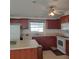 Well-equipped kitchen with ample wood cabinets and a breakfast bar at 1760 Dorothy Blvd, Lutz, FL 33558