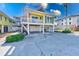 Two-story yellow house with a carport underneath at 1808 Gulf Blvd # 1, Indian Rocks Beach, FL 33785