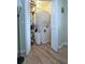 Stackable washer and dryer in a closet with wood flooring at 1808 Gulf Blvd # 1, Indian Rocks Beach, FL 33785