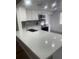 Modern kitchen with white cabinets, quartz countertops, and stainless steel appliances at 3259 Hilary Cir # 1A, Palm Harbor, FL 34684