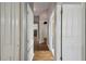 Light-filled hallway with wood floors and doors leading to bedrooms at 3512 Heron Island Dr, New Port Richey, FL 34655