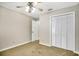 Bedroom with ceiling fan, carpet, and built-in closet at 409 Hickory Tree Cir, Seffner, FL 33584