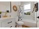 Modern bathroom with white vanity, bathtub, and geometric shower curtain at 4501 21St N St, St Petersburg, FL 33714