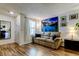 Living room with light taupe couch, wood floors, and large art at 4527 W La Villa Ln, Tampa, FL 33611