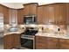 Stainless steel appliances and granite countertops in this well-lit kitchen at 5171 Bone Ln, Brooksville, FL 34604