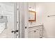 Small bathroom with white vanity and marble floors at 6117 E 113Th Ave, Temple Terrace, FL 33617