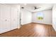 Bright bedroom with wood-look floors and double doors to closet at 6117 E 113Th Ave, Temple Terrace, FL 33617