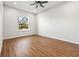 Bright bedroom featuring wood-look flooring and a large window at 6117 E 113Th Ave, Temple Terrace, FL 33617