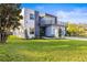 Modern two-story house with gray and white exterior, balcony, and attached garage at 6117 E 113Th Ave, Temple Terrace, FL 33617