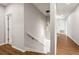 Long hallway with hardwood floors and modern light fixture at 6117 E 113Th Ave, Temple Terrace, FL 33617
