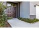 Modern house entrance with double doors and landscaping at 6117 E 113Th Ave, Temple Terrace, FL 33617