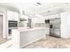 Modern kitchen with white cabinets, marble countertops, and island at 6117 E 113Th Ave, Temple Terrace, FL 33617
