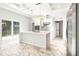 Modern kitchen with white cabinets, marble countertops and island at 6117 E 113Th Ave, Temple Terrace, FL 33617