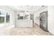 Modern kitchen with white cabinets, marble countertops, and island at 6117 E 113Th Ave, Temple Terrace, FL 33617