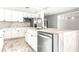 Modern kitchen with white cabinets and marble countertops at 6117 E 113Th Ave, Temple Terrace, FL 33617