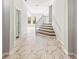 Elegant staircase with marble flooring and wrought iron railing at 6117 E 113Th Ave, Temple Terrace, FL 33617