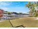Spacious grassy backyard with canal views and white fence at 620 Mirabay Blvd, Apollo Beach, FL 33572