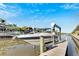 Waterfront home featuring a private boat dock with a lift on a sunny day at 620 Mirabay Blvd, Apollo Beach, FL 33572