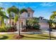 Two-story pink house with palm trees and metal roof at 620 Mirabay Blvd, Apollo Beach, FL 33572