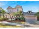 Two-story pink house with palm trees and metal roof at 620 Mirabay Blvd, Apollo Beach, FL 33572