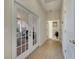 Bright hallway with French doors leading to a sunroom and additional rooms at 620 Mirabay Blvd, Apollo Beach, FL 33572
