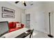Spacious home office with built-in workspace and red couch at 620 Mirabay Blvd, Apollo Beach, FL 33572