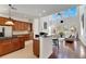 Open kitchen with wooden cabinets, granite counters, and stainless steel appliances at 620 Mirabay Blvd, Apollo Beach, FL 33572