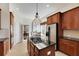 Spacious kitchen with island, stainless steel appliances, and dark wood cabinets at 620 Mirabay Blvd, Apollo Beach, FL 33572