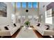 Spacious living room with hardwood floors, white sofas and a high ceiling at 620 Mirabay Blvd, Apollo Beach, FL 33572