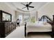 Main bedroom with king-size bed, dresser, and two armchairs at 620 Mirabay Blvd, Apollo Beach, FL 33572