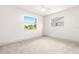 Bright bedroom featuring neutral walls and carpet, plus two windows at 72 Gulfwinds Dr, Palm Harbor, FL 34683