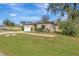 House exterior view, showing a tan house with landscaping at 807 Garden Oaks Sq, Seffner, FL 33584