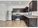 Modern kitchen with dark cabinets and stainless steel appliances at 807 Garden Oaks Sq, Seffner, FL 33584