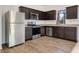 Dark brown cabinets, granite countertops, stainless steel appliances at 807 Garden Oaks Sq, Seffner, FL 33584