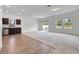 Open living room and kitchen with hardwood and carpeted floors at 807 Garden Oaks Sq, Seffner, FL 33584