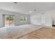 Bright, spacious living room with carpet and wood flooring, neutral color palette, and sliding glass doors at 807 Garden Oaks Sq, Seffner, FL 33584