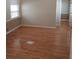 Spacious bedroom with wood-look flooring and neutral walls at 816 N Jasmine Ave, Tarpon Springs, FL 34689