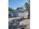 Single-wide manufactured home with carport and landscaping at 816 N Jasmine Ave, Tarpon Springs, FL 34689