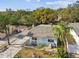 Aerial view of a small light blue house with a carport and a small yard at 8416 N Semmes St, Tampa, FL 33604