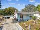 Single story light blue house, carport and yard at 8416 N Semmes St, Tampa, FL 33604