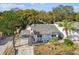 An aerial view of a light blue house with a gray roof and a small yard at 8416 N Semmes St, Tampa, FL 33604