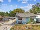 Small light blue house with carport and yard at 8416 N Semmes St, Tampa, FL 33604