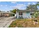 Small light blue house with carport and yard at 8416 N Semmes St, Tampa, FL 33604