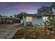 Light blue house with carport and small yard at 8416 N Semmes St, Tampa, FL 33604