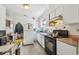 Kitchen with white cabinets and a stove at 8416 N Semmes St, Tampa, FL 33604