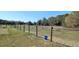 Wooden fence bordering a grassy field and trees at 13621 Mcintosh Rd, Thonotosassa, FL 33592