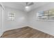 Well-lit bedroom with wood-look floors and two windows at 10206 Lola St, Tampa, FL 33612